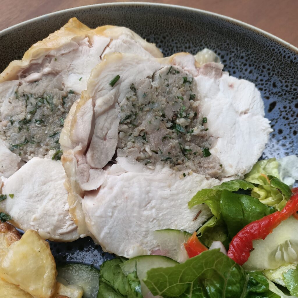 photo of dinner with meat, potatoes and salad