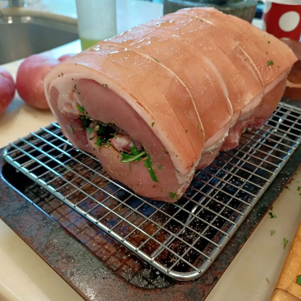 photo of pork rolled and tied with string on a metal rack