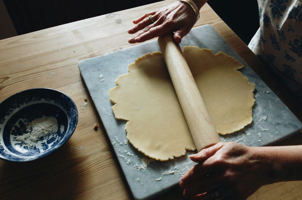 photo of someone rolling out pastry dough