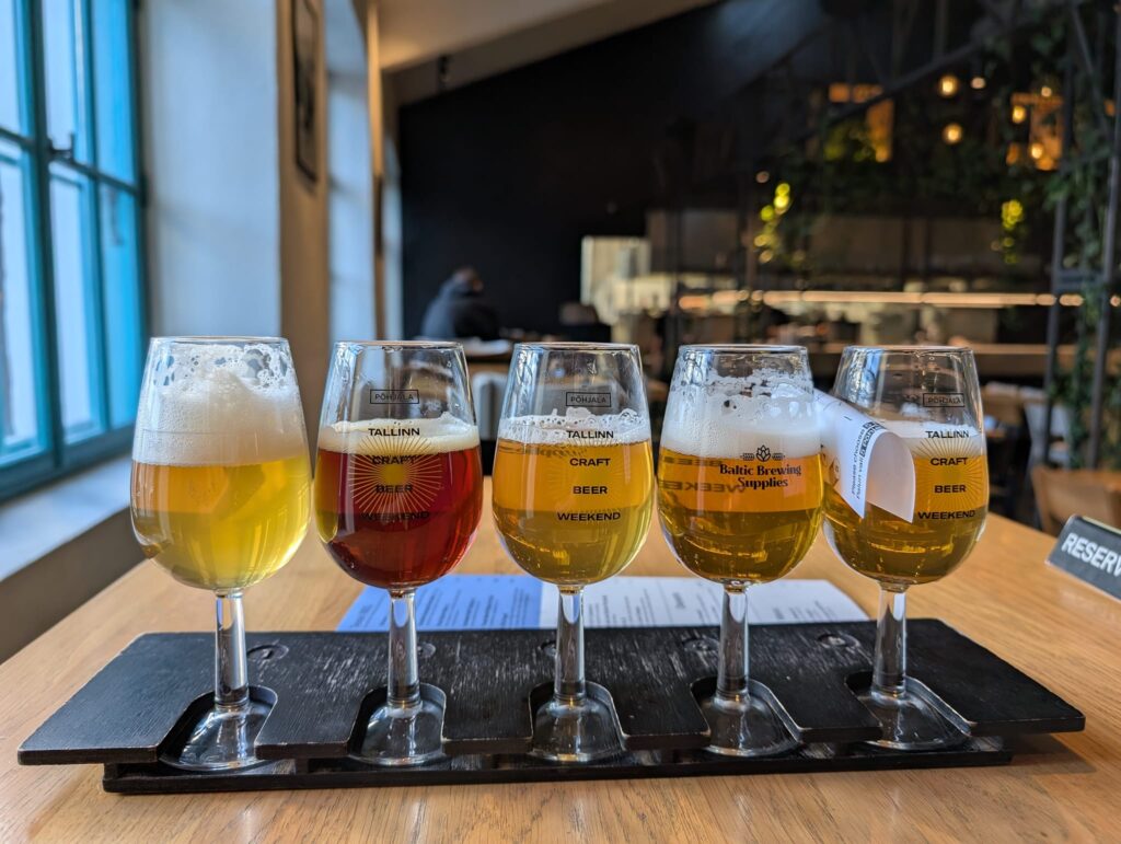 photo of five beers lined up all different shades of brown