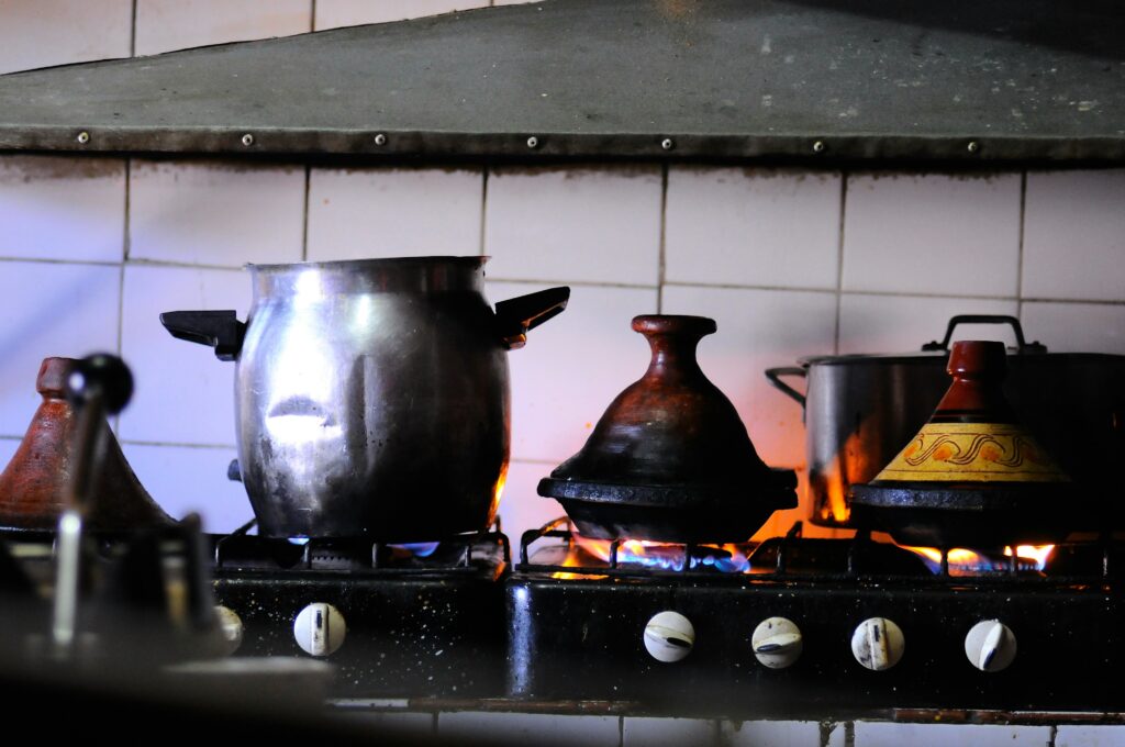 photo of metal and ceramic pots on a gas fire stove