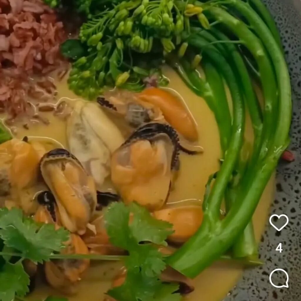 mussels in a sauce in a grey bowl