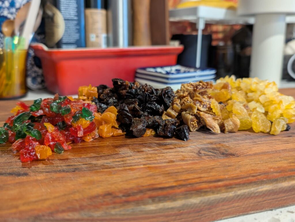 photo of lots of dried and glace fruit on a wooden board