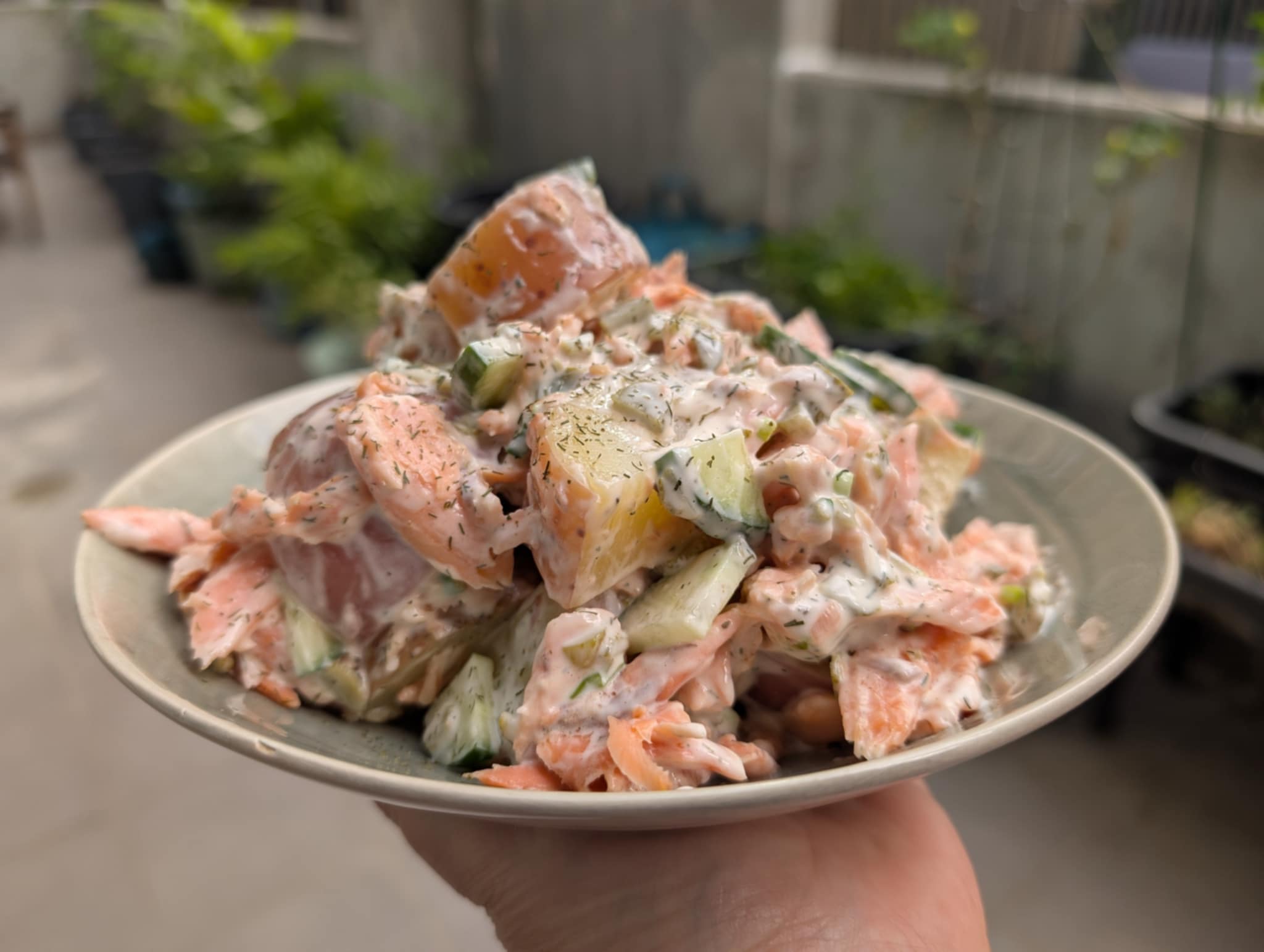 photo of a bowl with potao and trout salad covered in mayonnaise