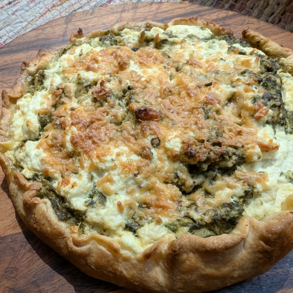 photo of a pastry open face tart with spinach and cheese