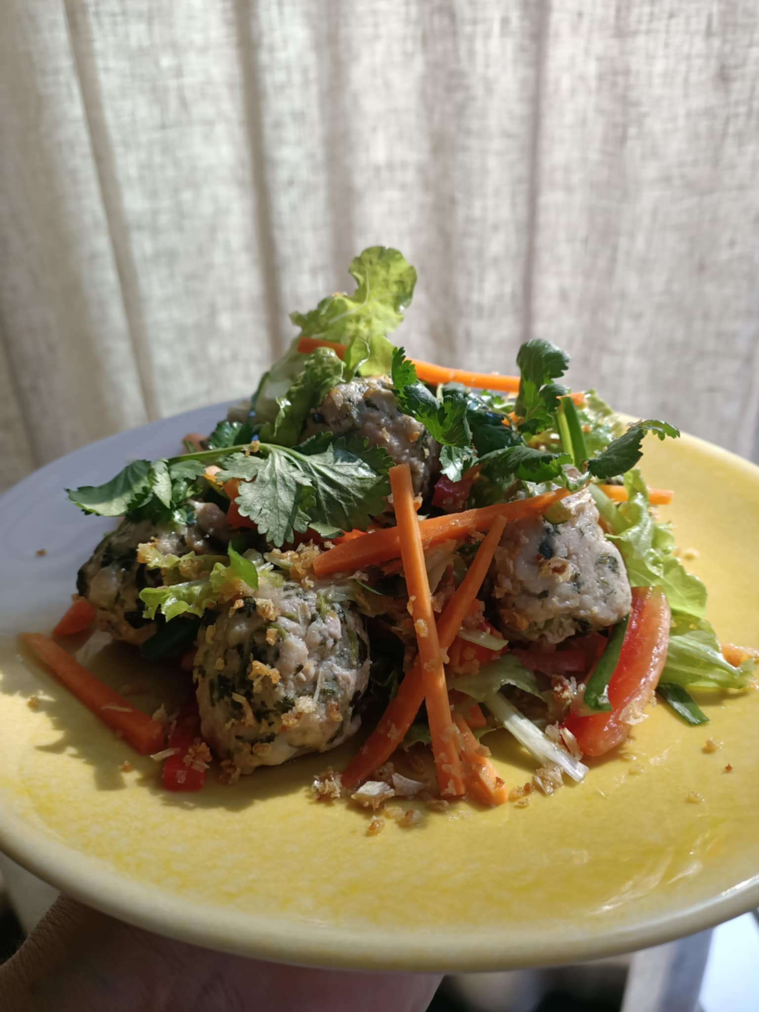 photo of a colourful salad on a yellow plate