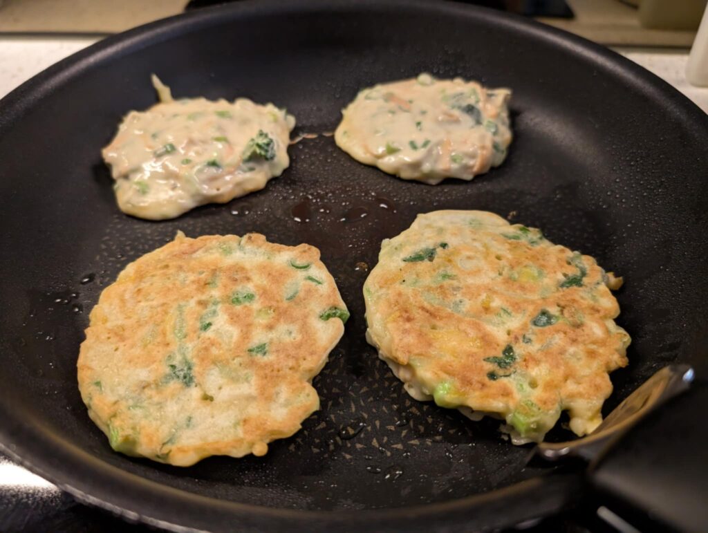 photo of savoury vegetable pancakes cooking in a frypan